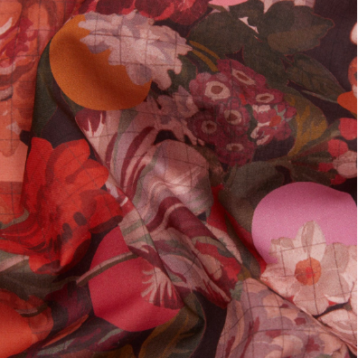 A close-up of Liberty Fabrics cotton fabric with a dense floral print in red, pink, orange, and green tones, with a dark background. A text overlay at the bottom reads 'Liberty Fabrics Myrtle and Mary C Tana Lawn Cotton 