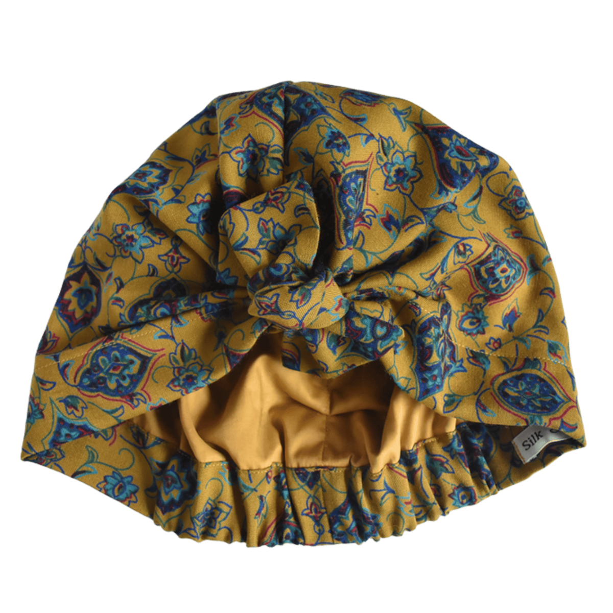 A mustard yellow vintage liberty fabric hair turban with a blue and purple floral pattern, featuring a elasticised ruffled bottom, silk or cotton lined