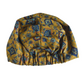A mustard yellow vintage liberty fabric hair turban with a blue and purple floral pattern, featuring a elasticised ruffled bottom, silk or cotton lined