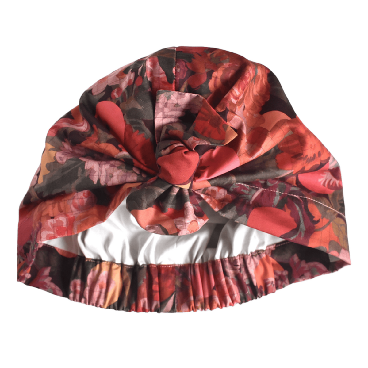 A floral-patterned turban-style cap with a large bow at the top and an elasticized gathered edge, shown on a plain white background.