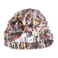 Liberty Cottage Garden floral print turban or sleep bonnet with a large bow on top and a elasticated back, shown against a plain white background.
