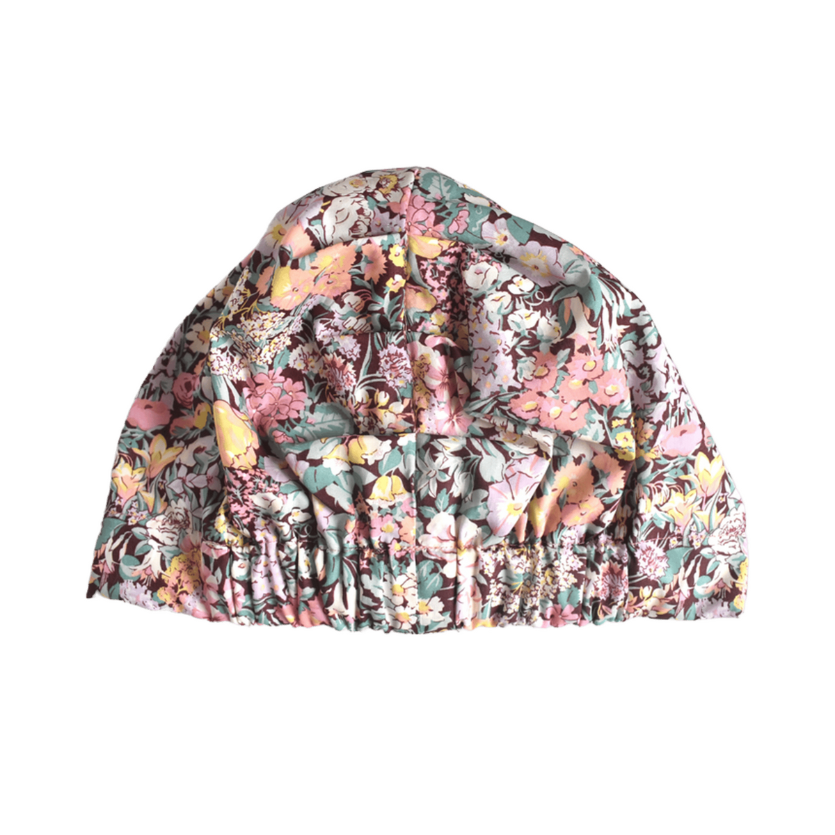 Liberty Cottage Garden floral print turban or sleep bonnet with a large bow on top and a elasticated back, shown against a plain white background.