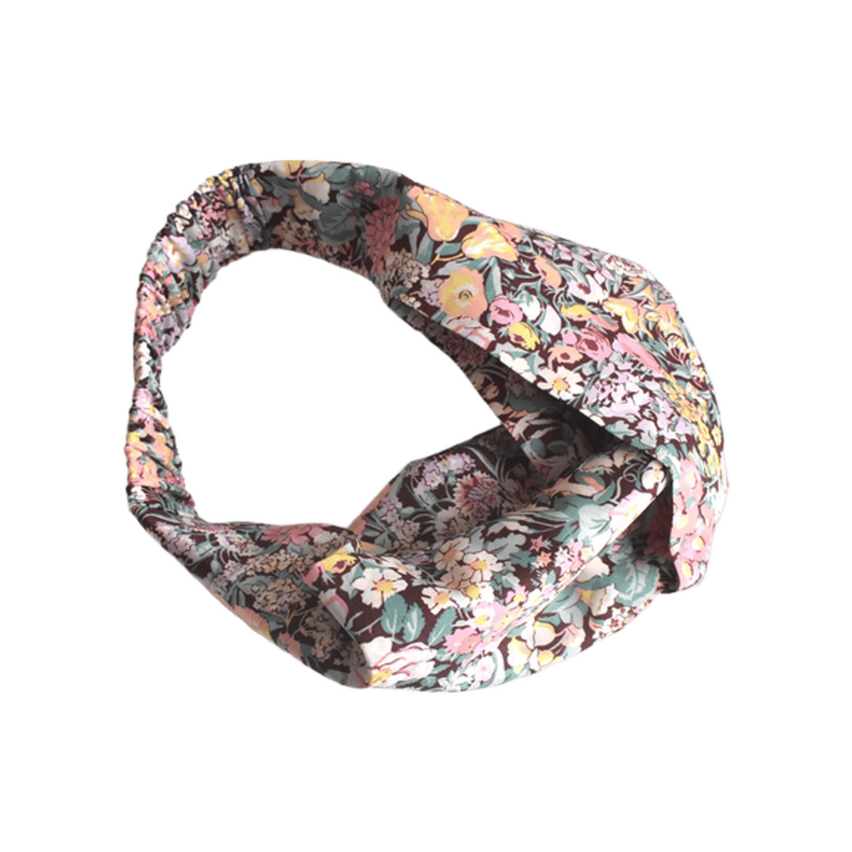 A knotted fabric headband featuring a dense Liberty Cottage Garden floral pattern with pink, yellow, green, and blue tones on a dark background, isolated on a white background.