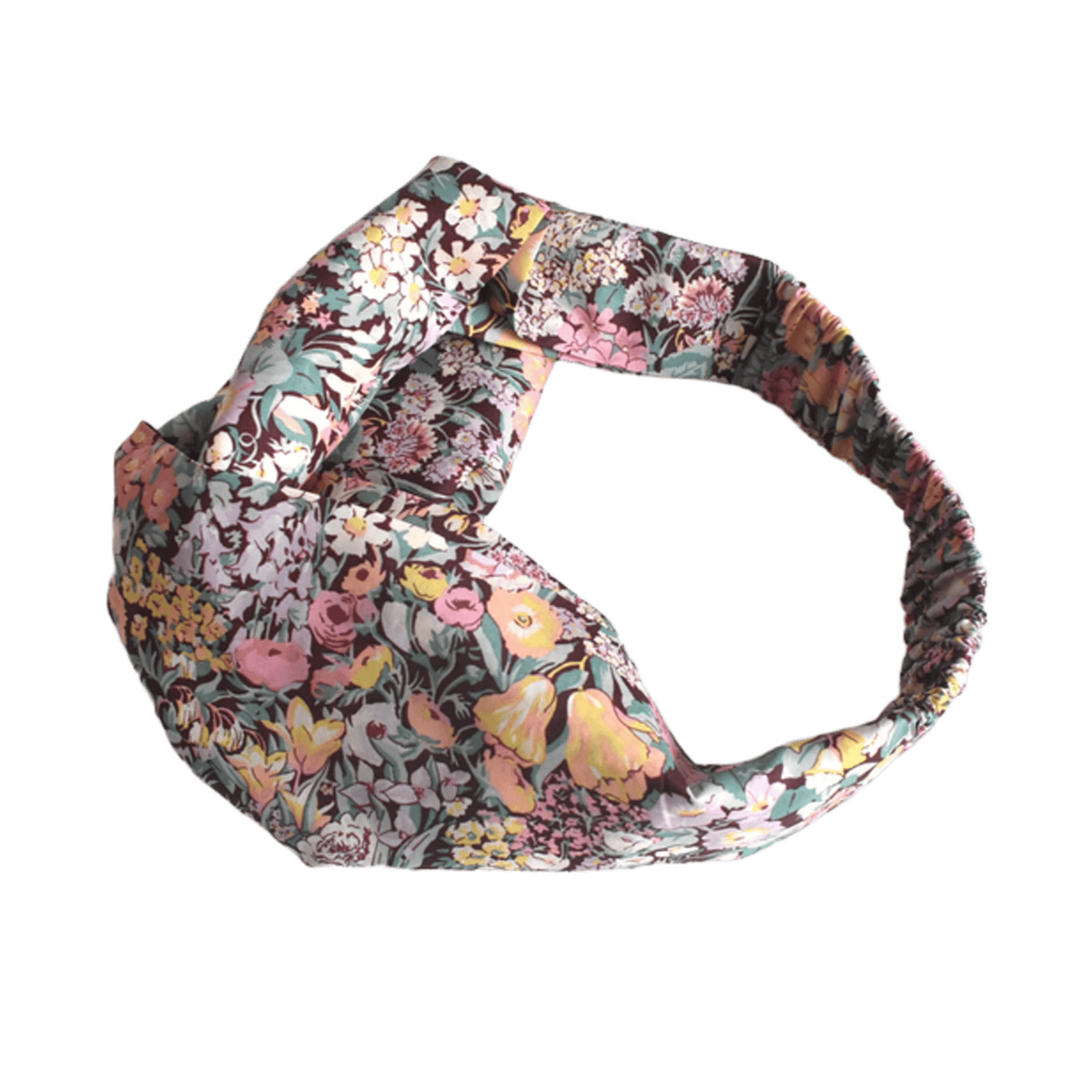 A knotted fabric headband featuring a LIberty Cottage Garden floral on a dark background, isolated on a white background.