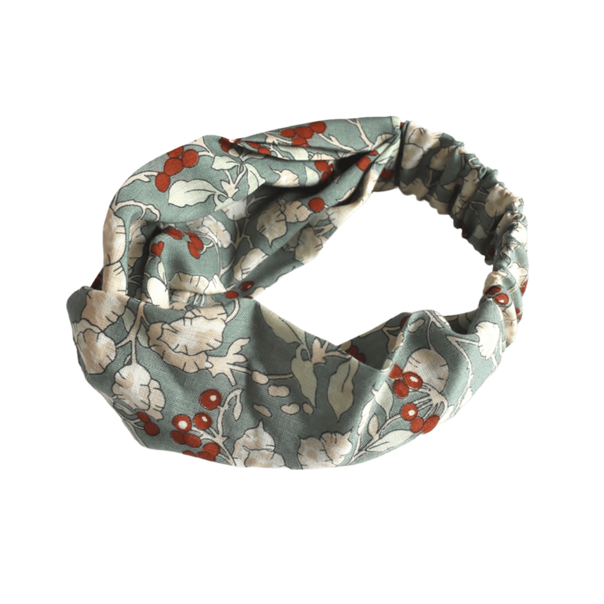 A fabric headband with a twisted knot design, featuring a muted sage green background with a floral pattern of white flowers and small red berries, shown on a plain white background.