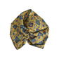 A mustard yellow fabric twisted headwrap or turban with a blue floral and geometric pattern, in varuna wool from hair accessory brand Silk & Lawn